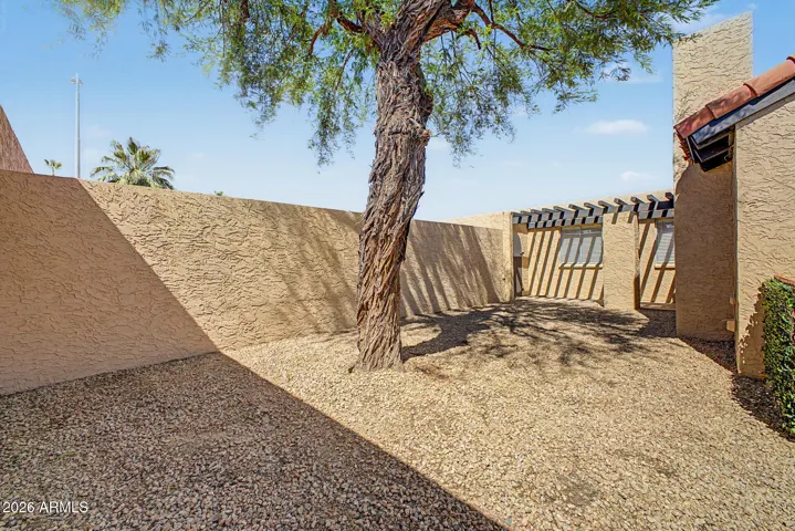 View looking back towards front gate and entry, wrap around yard