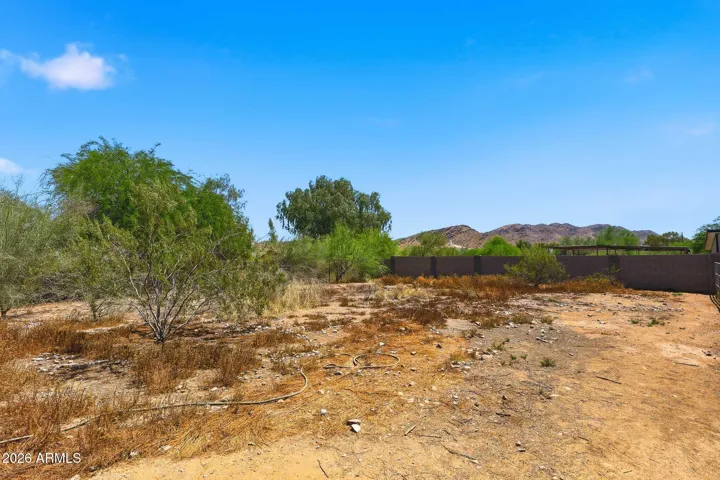 Large unused back portion of the lot. Perfect for a casita, garage, horses, or sports courts.