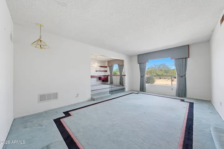 Formal Sitting room with a large picture window looking to the front landscape.