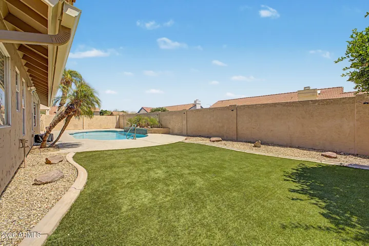 Backyard with turf and pool