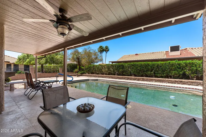 Enter into the beautiful and very private backyard with travertine tiles and a wonderful Pebble-Tec Pool.