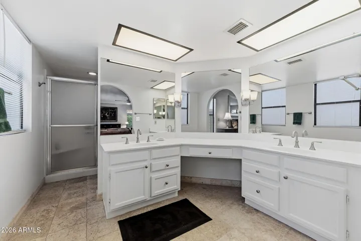 Primary Ensuite with double sinks, Walk-in Shower, and private toilet room.