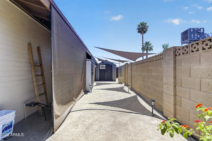 Large storage shed, shade screens & shade sails convey to buyer.