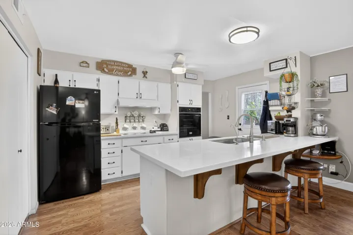 Electric cooktop, wall oven, quartz countertops & breakfast bar.