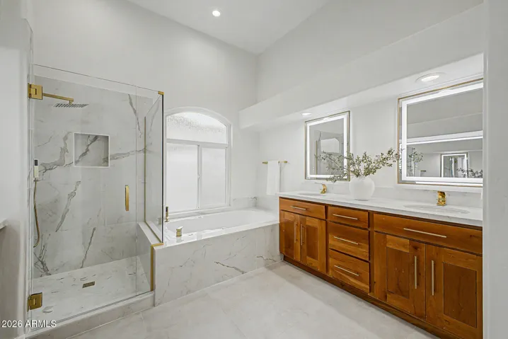 Spa inspired primary bathroom with large jetted tub