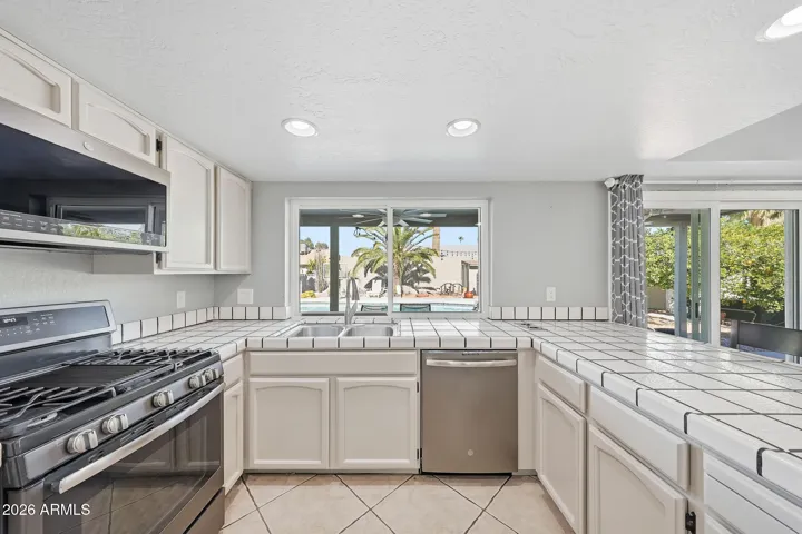 All cabinets refinished with updated stainless steel appliance package, including a 4-burner gas stove with griddle