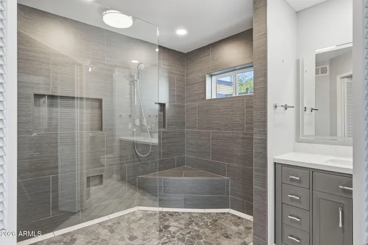 NEW custom floor-to-ceiling tile work with shower ledge and niche