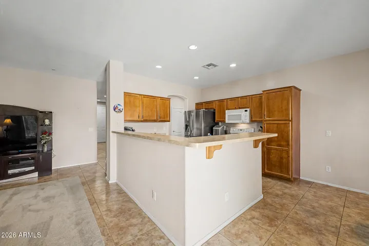 A kitchen with counter space for stools.
