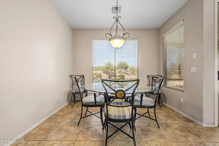 A dining area overlooking the pool and golf course.