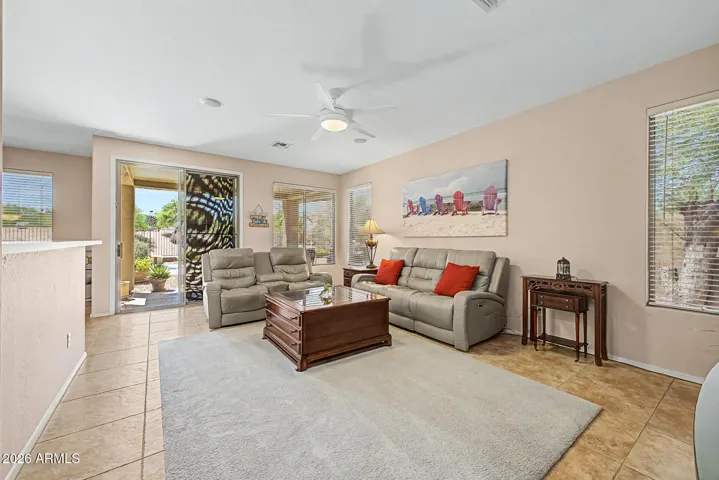 The room features a spacious layout with a sliding patio door.