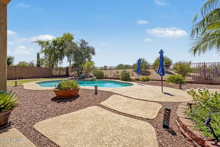 Enjoy the breathtaking view of the sparkling pool and golf course from the patio, where you’ll be enveloped in privacy from every angle.