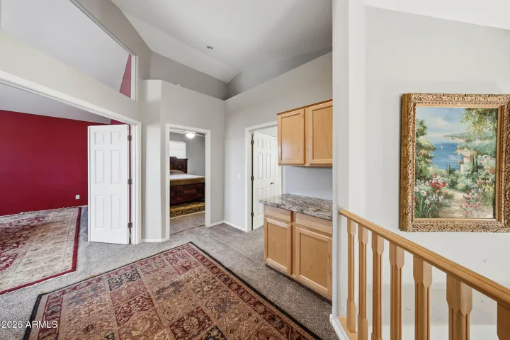 With cabinets for storage and a granite counter.