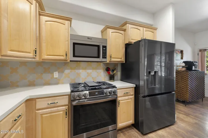 Kitchen with newer appliances & gas stove/oven.