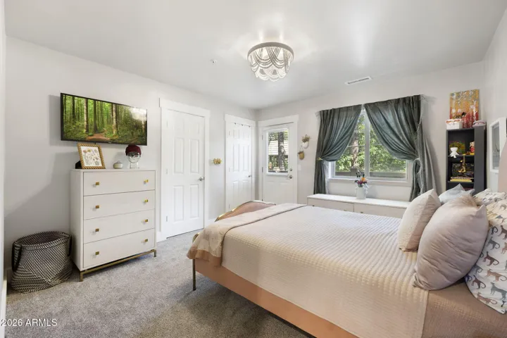 Large guest bedroom with own patio deck with a view of golf course hole 4.