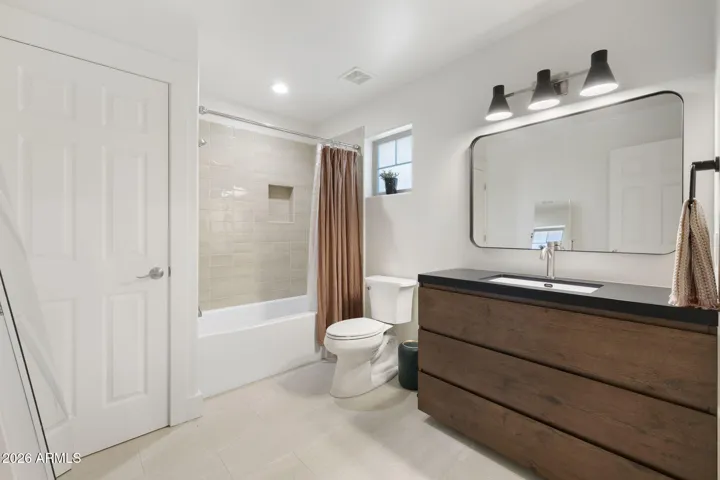 Newly remodeled guest bathroom with new tub, toilet, cabinetry, sink & lights/