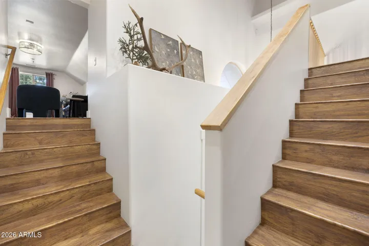 Split staircase that leads to upstairs bedrooms/bathroom and the second stairs leading to separate large bonus room.