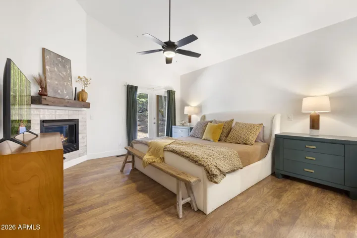 Comfortable & cozy primary bedroom with gas fireplace.