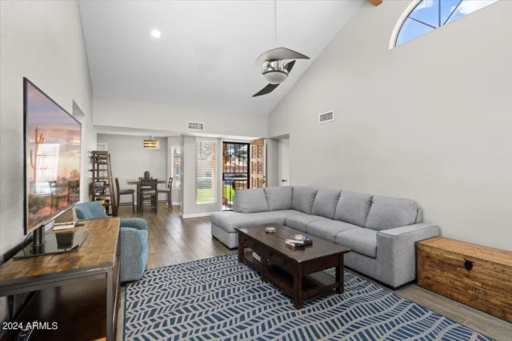 Spacious open living area showcasing soaring ceilings and indoor-outdoor flow