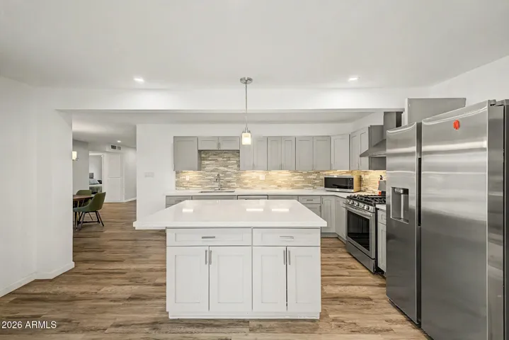 This inviting space brings the kitchen and living area together beautifully, creating an easy place to gather, relax, or entertain. The updated finishes, spacious island, and open flow give the home a fresh, comfortable feel that fits perfectly with the Sun City lifestyle.