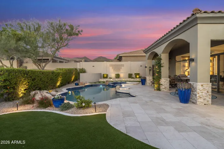Heated pool, spa, extended back patio w/ travertine pavers, fire pit, and misting system.