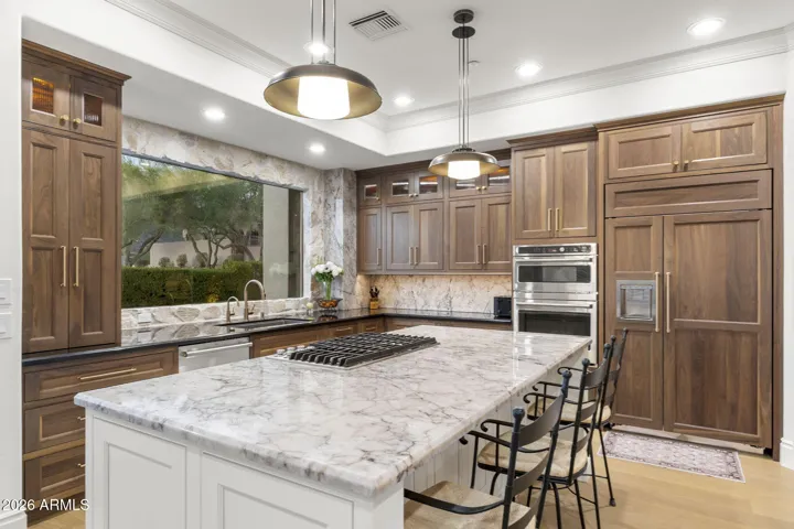 Custom soft-close cabinetry, gas cook-top, built in fridge, quartzite island and more! See document section
