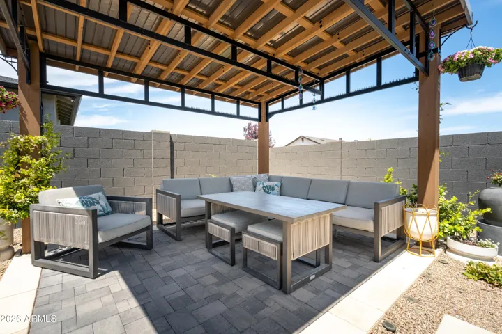Private covered pergola with stylish seating and dining space—perfect for outdoor entertaining.