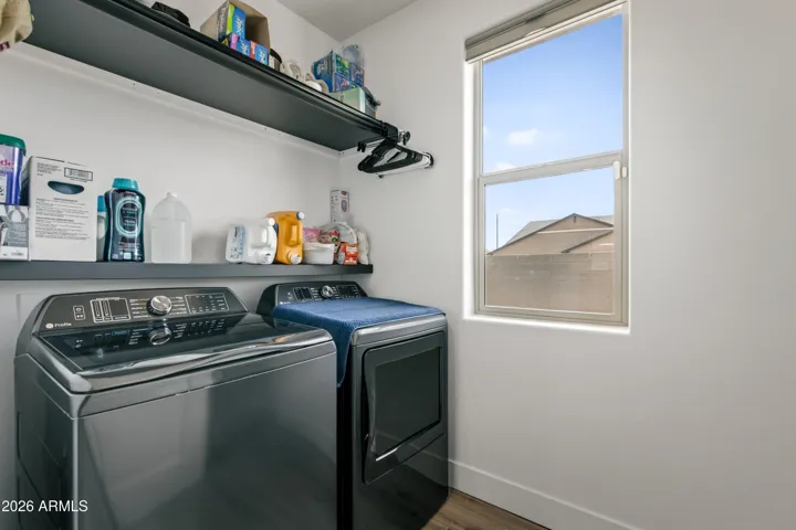 Large laundry room with shelving for additional storage