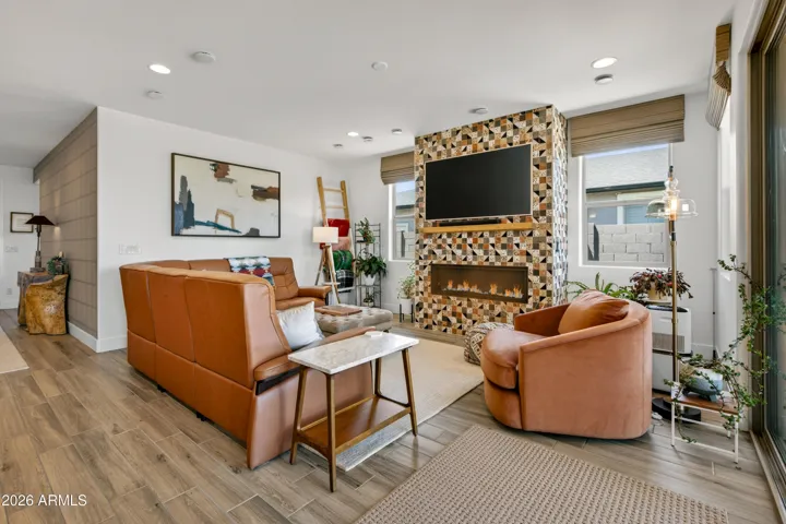 Spacious living area with a tiled entertainment wall and a cozy fireplace