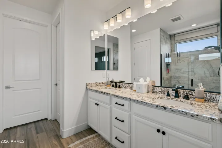 Spacious primary bath with double sinks and large walk in shower
