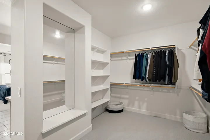 Extra large walk in closet with custom mirror in primary suite