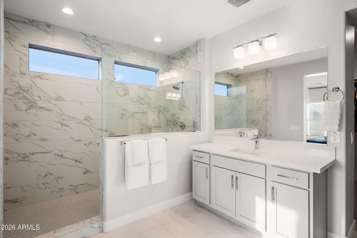 Super spa shower in primary suite, split vanities, quartz countertops and separate water closet.
