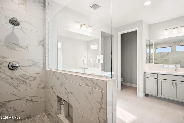 Super spa shower in primary suite, split vanities, quartz countertops and separate water closet.