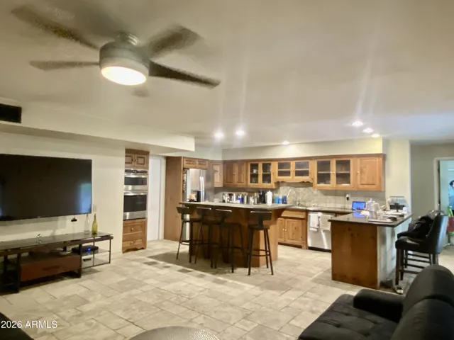 Knotty Pine cabinetry with timeless granite counters and travertine floors