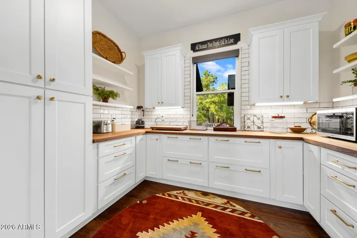 Butler's pantry with built-in upright freezer, storage, counter space for small appliances, etc.