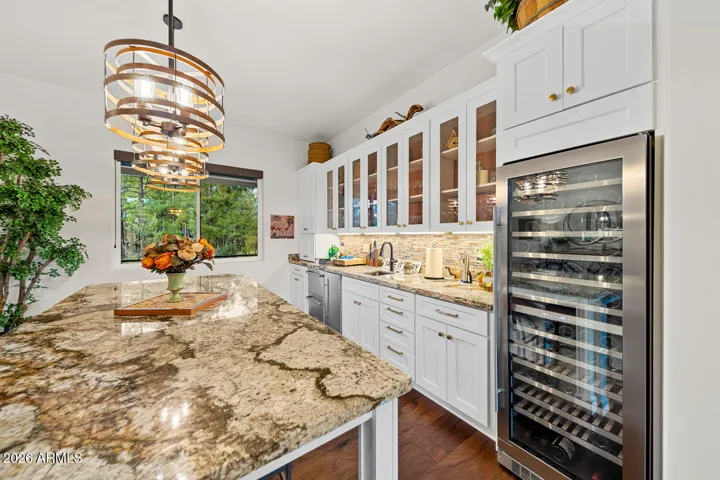 Built-in wine fridge, ice maker, mini fridge & wetbar.