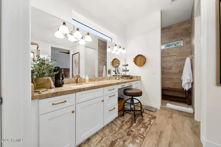Master bathroom with extensive counter space and a tile walk-in shower