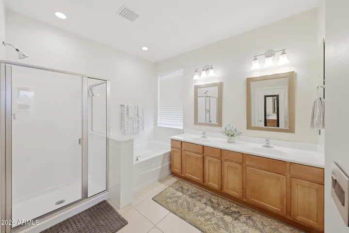 Dual sinks, upgrade mirrors, lighting; tub and shower