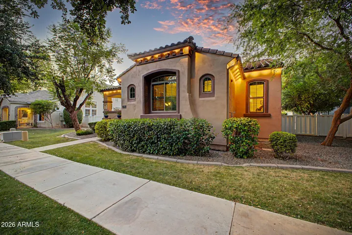 The inviting front porch, lush, mature landscaping, and undeniable curb appeal set a warm, memorable tone.