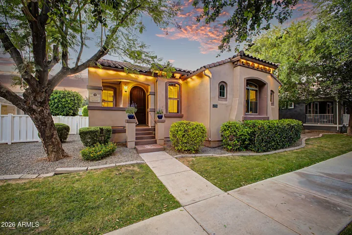 The inviting front porch, lush, mature landscaping, and undeniable curb appeal set a warm, memorable tone.