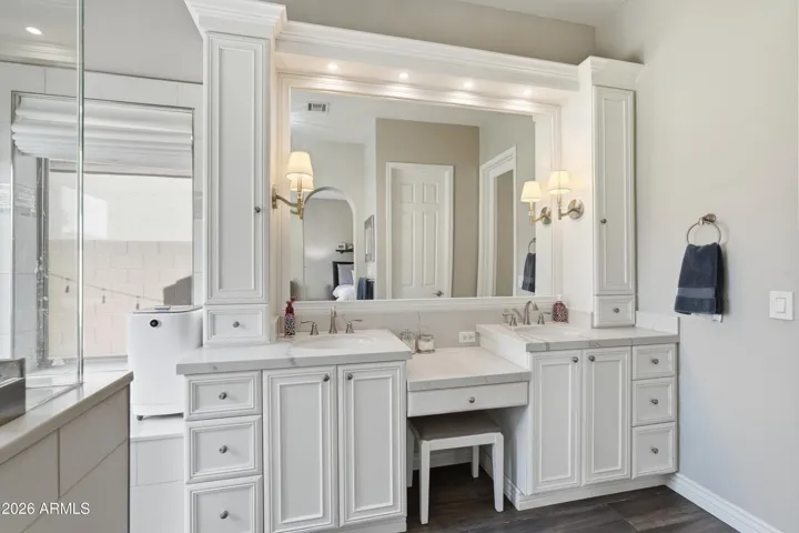 Custom cabinetry, inset lighting, & designer sconces