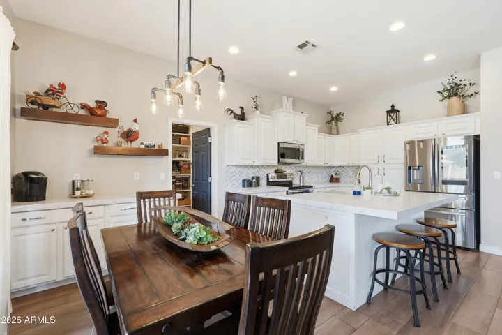 Remodeled kitchen includes quartz countertops, staggered cabinetry, oversized island w/ bar seating,