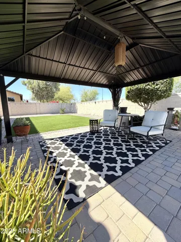 Entertainer’s backyard with low-maintenance landscaping and a large gazebo, ideal for hosting guests.