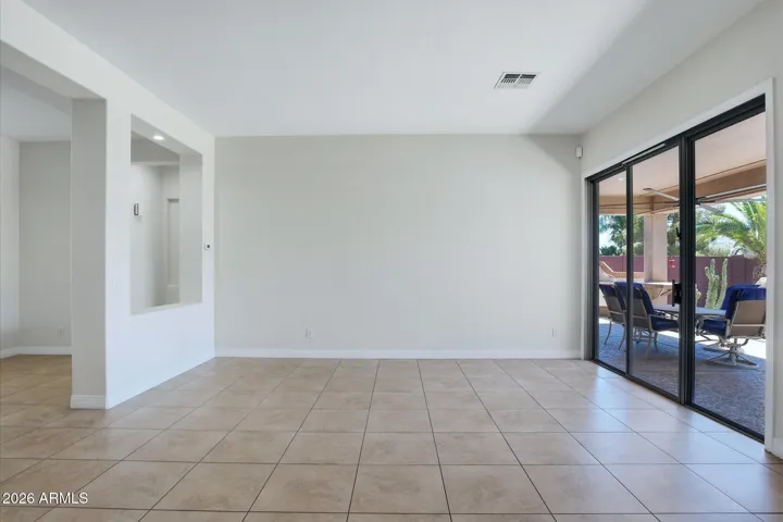 Formal Living Room with view to Rear yard and pool area