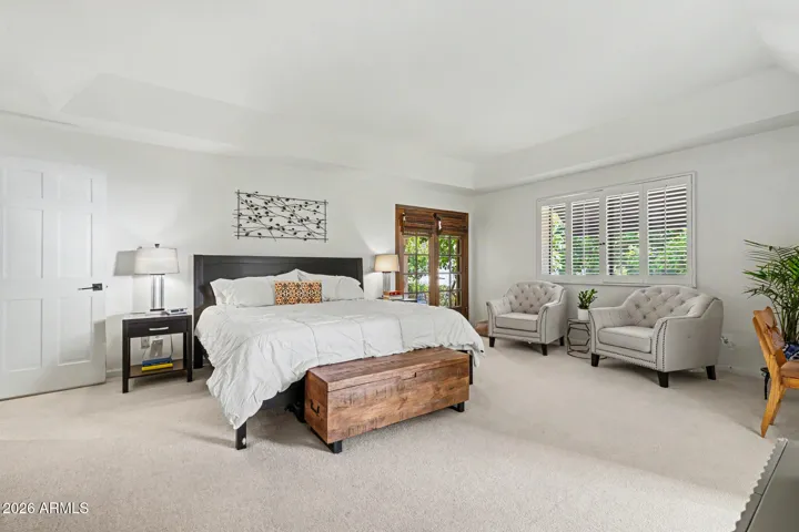Grand master suite with wood french doors out to backyard & patio