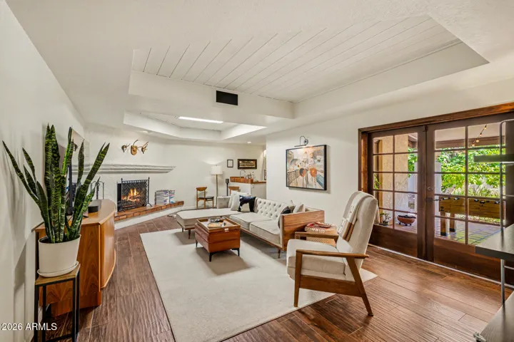Big open Family room with fireplace, wet bar, skylight & cabana bathroom, wood french doors out to extensive tiled patio & backyard.