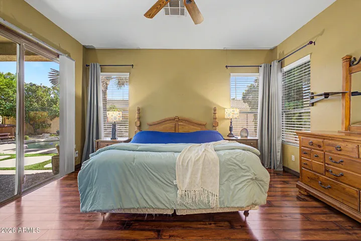 Primary Bedroom with sliding glass door to the backyard oasis