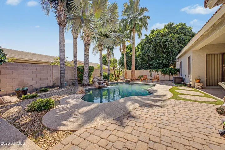 Backyard oasis with beautiful play pool and rock waterfall