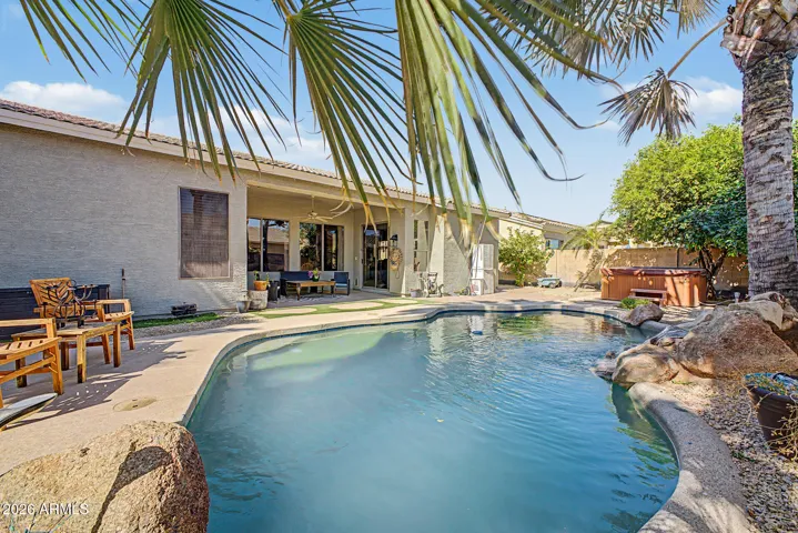 Backyard oasis with beautiful play pool and rock waterfall