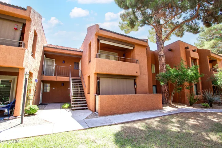Classic Southwest architecture with mature trees, private balconies, and easy ground-floor access