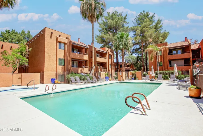 "Dive into resort-style living — the sparkling heated pool is steps away, surrounded by lounge chairs and towering palms. Perfect for snowbirds and weekend recharges."